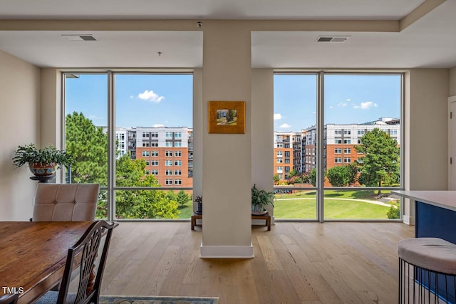 214 Hunt St Unit 503, Durham, NC 27701 - dining area featuring expansive windows, hardwood / wood-style floors, and plenty of natural light