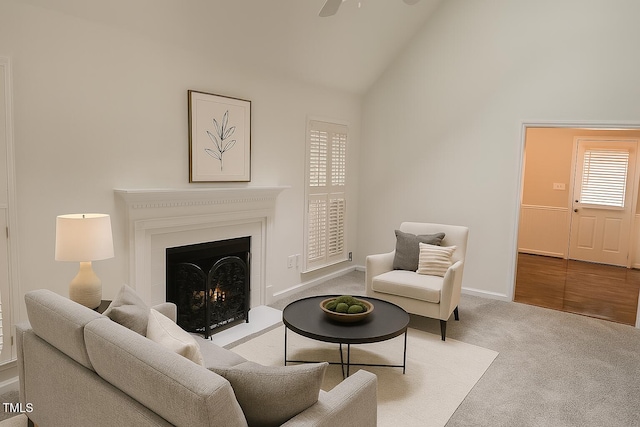 112 W Skyhawk Dr, Cary, NC 27519 - living area with carpet floors, ceiling fan, a lit fireplace, and high vaulted ceiling