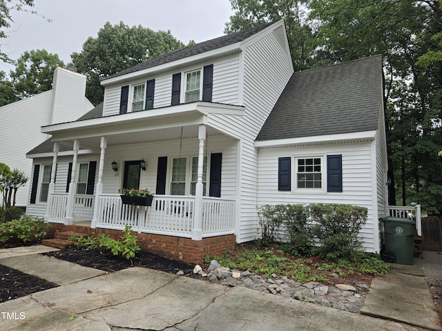112 W Skyhawk Dr, Cary, NC 27519 - view of front of house featuring a porch, a shingled roof, and a chimney