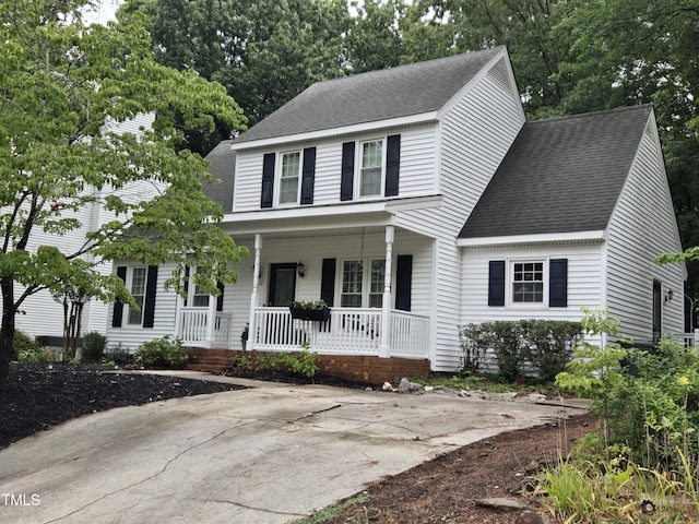 112 W Skyhawk Dr, Cary, NC 27519 - view of front of house with a porch, a shingled roof, and view of scattered trees