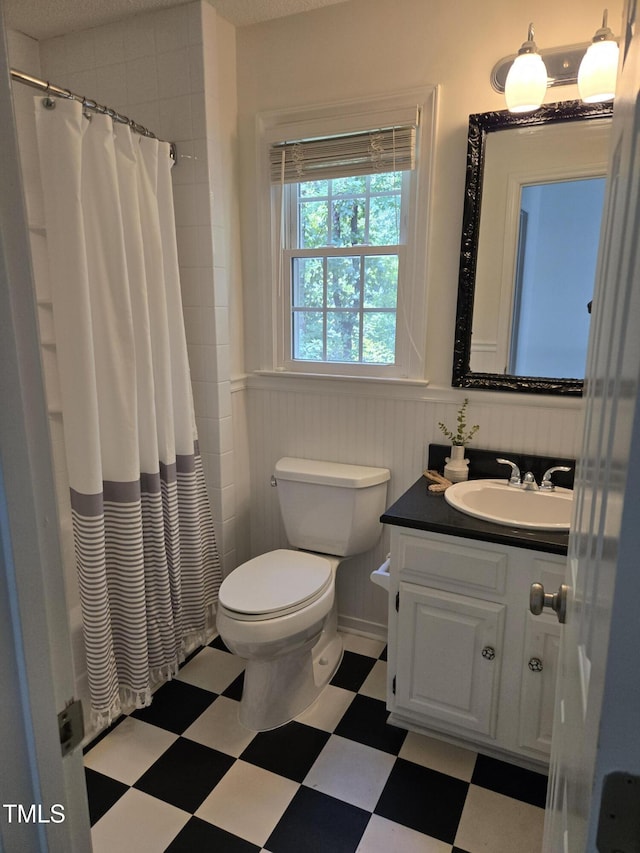 112 W Skyhawk Dr, Cary, NC 27519 - full bathroom with tile patterned floors, vanity, wainscoting, and shower / tub combo with curtain