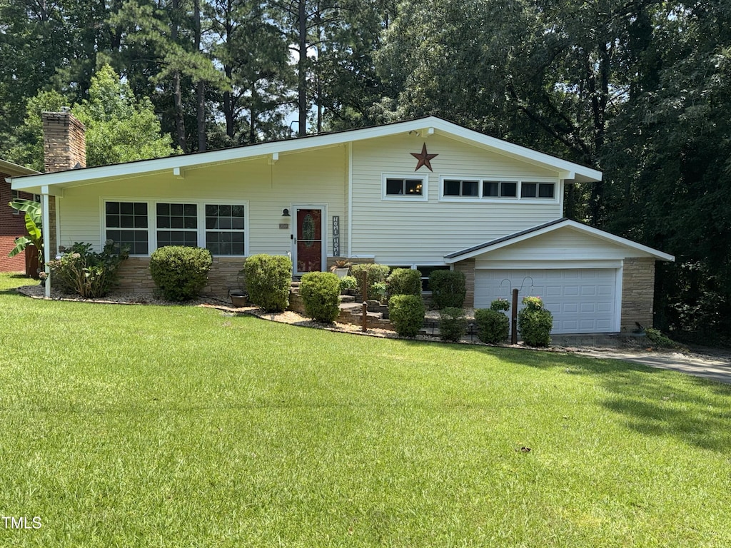 100 Hillcrest Dr, Smithfield, NC 27577 - tri-level home with a chimney, a front lawn, an attached garage, and stone siding