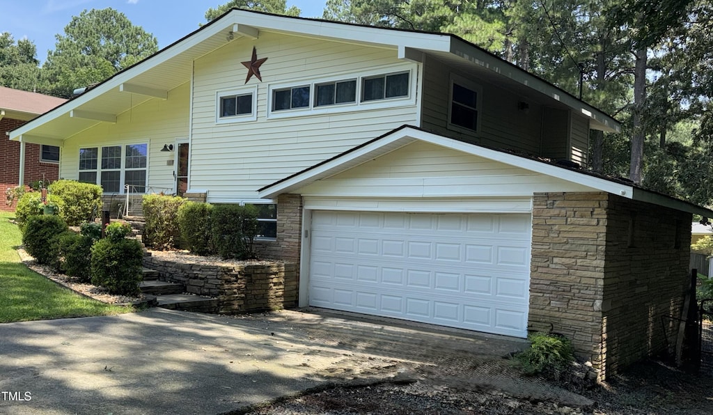 100 Hillcrest Dr, Smithfield, NC 27577 - view of front of home featuring stone siding, driveway, and an attached garage