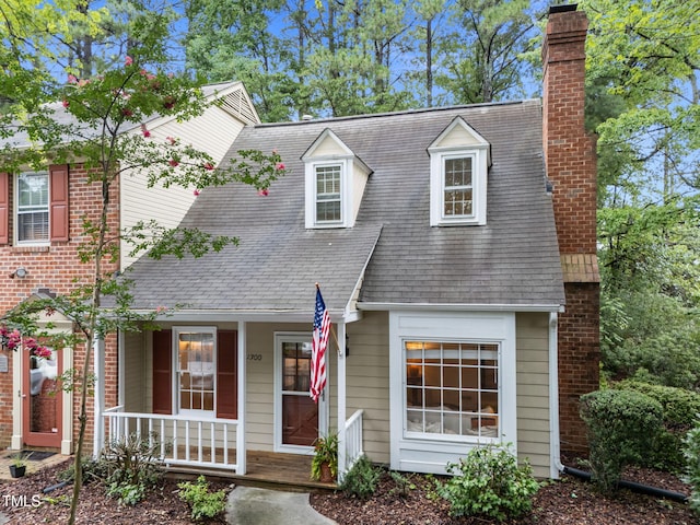 1300 Dylan Heath Ct, Raleigh, NC 27608 - cape cod-style house featuring covered porch, a chimney, and a shingled roof