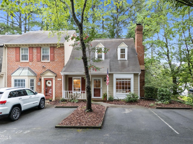 1300 Dylan Heath Ct, Raleigh, NC 27608 - view of front of house with a chimney and uncovered parking