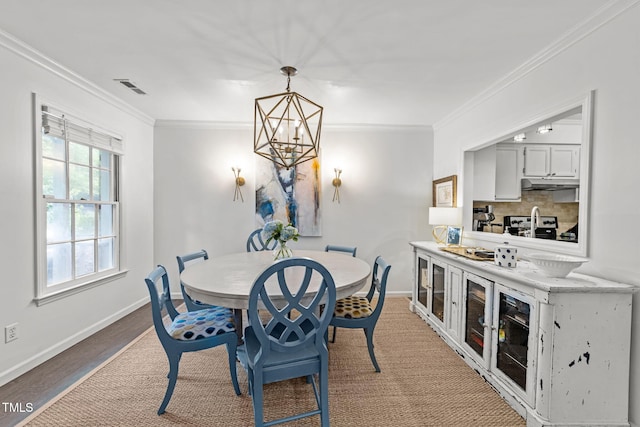1300 Dylan Heath Ct, Raleigh, NC 27608 - dining area featuring ornamental molding and a chandelier