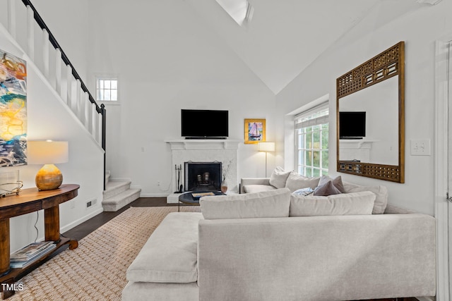 1300 Dylan Heath Ct, Raleigh, NC 27608 - living area with stairs, high vaulted ceiling, a fireplace, and dark wood-style floors