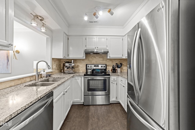 1300 Dylan Heath Ct, Raleigh, NC 27608 - kitchen with stainless steel appliances, under cabinet range hood, white cabinetry, light stone countertops, and crown molding