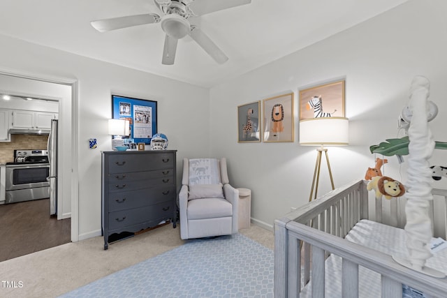 1300 Dylan Heath Ct, Raleigh, NC 27608 - bedroom with freestanding refrigerator, carpet, a nursery area, and ceiling fan