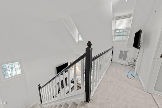 1300 Dylan Heath Ct, Raleigh, NC 27608 - hall featuring plenty of natural light, carpet, an upstairs landing, and a towering ceiling