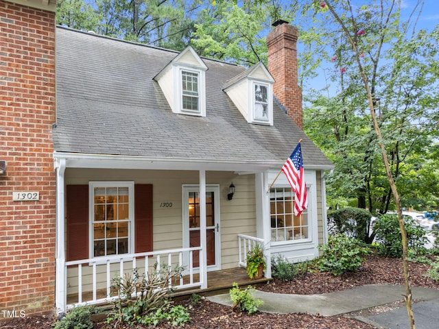 1300 Dylan Heath Ct, Raleigh, NC 27608 - cape cod-style house featuring a chimney, a porch, and a shingled roof