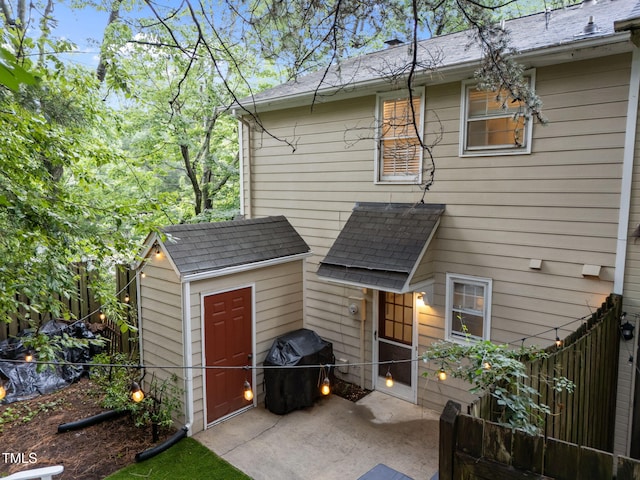 1300 Dylan Heath Ct, Raleigh, NC 27608 - back of house with a shed, roof with shingles, and a patio