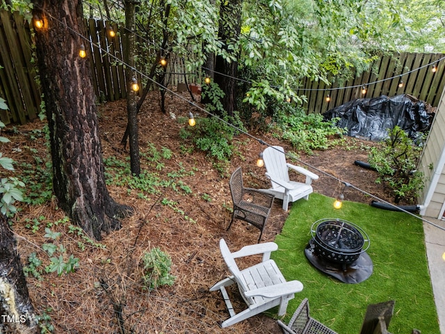 1300 Dylan Heath Ct, Raleigh, NC 27608 - fenced backyard with an outdoor fire pit