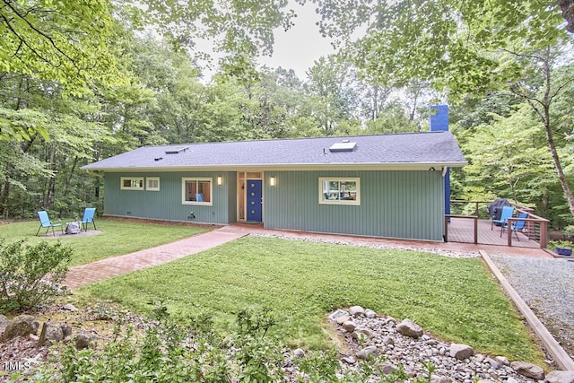 1026 Highland Woods Rd, Chapel Hill, NC 27517 - ranch-style house featuring a chimney, a wooden deck, a front lawn, and roof with shingles