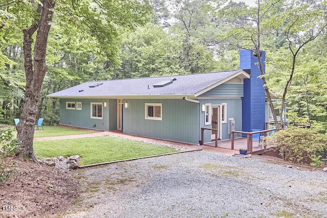 1026 Highland Woods Rd, Chapel Hill, NC 27517 - view of front of property with a chimney, a front lawn, roof with shingles, and a wooden deck