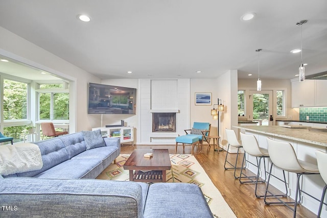 1026 Highland Woods Rd, Chapel Hill, NC 27517 - living room featuring recessed lighting, a large fireplace, and light wood-type flooring