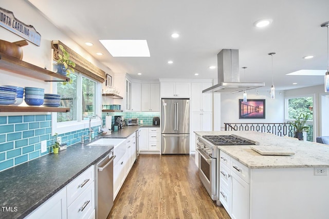 1026 Highland Woods Rd, Chapel Hill, NC 27517 - kitchen with appliances with stainless steel finishes, a skylight, open shelves, island exhaust hood, and plenty of natural light