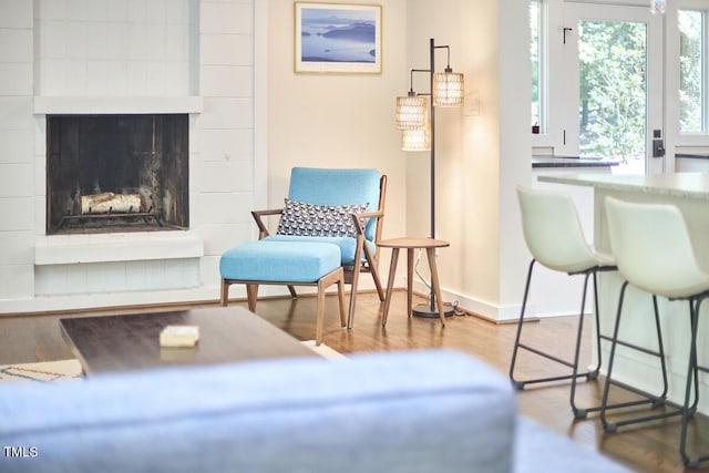 1026 Highland Woods Rd, Chapel Hill, NC 27517 - sitting room featuring a fireplace with raised hearth and wood finished floors