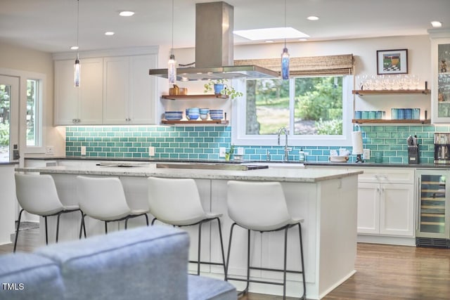 1026 Highland Woods Rd, Chapel Hill, NC 27517 - kitchen featuring island range hood, beverage cooler, open shelves, a breakfast bar, and white cabinets