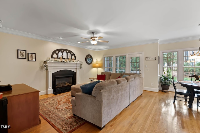 1224 Marshall Farm St, Wake Forest, NC 27587 - living area featuring healthy amount of natural light, light wood-style flooring, a fireplace with flush hearth, ceiling fan, and crown molding