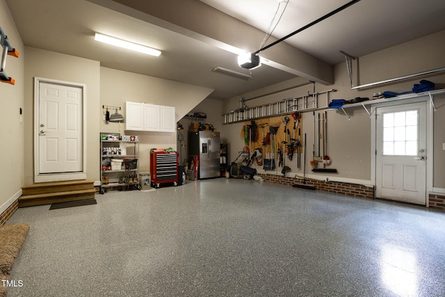 1224 Marshall Farm St, Wake Forest, NC 27587 - garage featuring stainless steel fridge with ice dispenser and a garage door opener