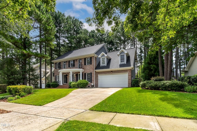 1224 Marshall Farm St, Wake Forest, NC 27587 - view of front facade featuring driveway, brick siding, a front lawn, a garage, and roof with shingles