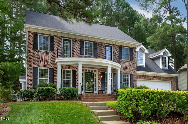 1224 Marshall Farm St, Wake Forest, NC 27587 - colonial home with brick siding, covered porch, a front lawn, and roof with shingles