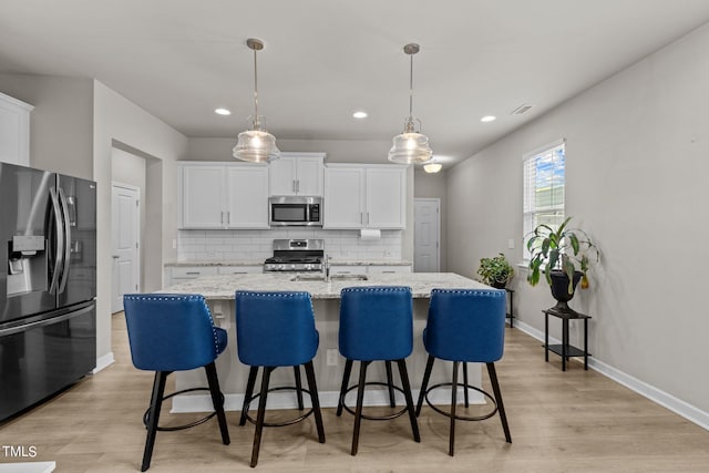 36 Mae Ct, Roxboro, NC 27573 - kitchen featuring stainless steel appliances, decorative backsplash, light wood-type flooring, recessed lighting, and white cabinets