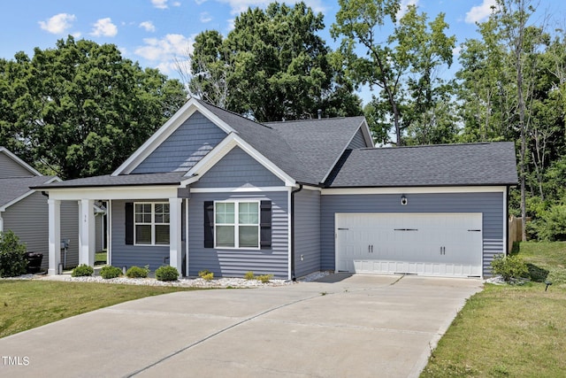 36 Mae Ct, Roxboro, NC 27573 - view of front of property with driveway, an attached garage, a front yard, roof with shingles, and a porch