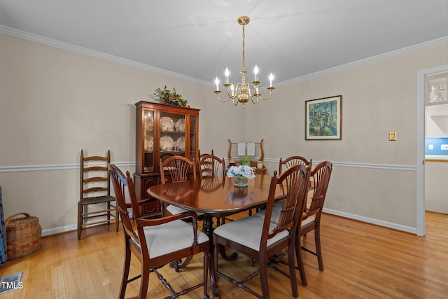 906 Grove St, Chapel Hill, NC 27517 - dining room with light wood-type flooring, a chandelier, and ornamental molding