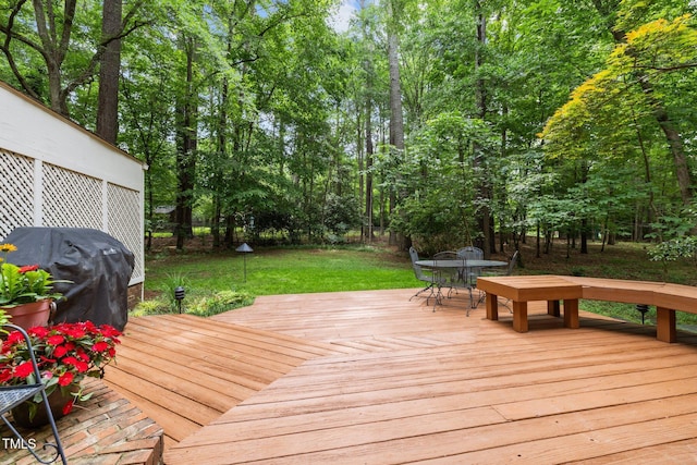 906 Grove St, Chapel Hill, NC 27517 - wooden terrace featuring outdoor dining area, a lawn, grilling area, and view of scattered trees