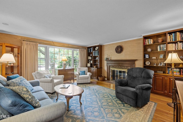 906 Grove St, Chapel Hill, NC 27517 - living room featuring light wood-style flooring, a fireplace, and crown molding