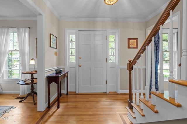 906 Grove St, Chapel Hill, NC 27517 - entryway with stairway, plenty of natural light, light wood-style floors, crown molding, and wallpapered walls