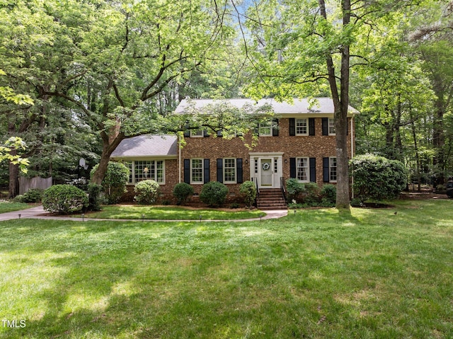 906 Grove St, Chapel Hill, NC 27517 - colonial-style house featuring brick siding and a front lawn