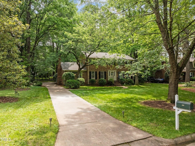 906 Grove St, Chapel Hill, NC 27517 - view of front facade featuring a front yard and brick siding
