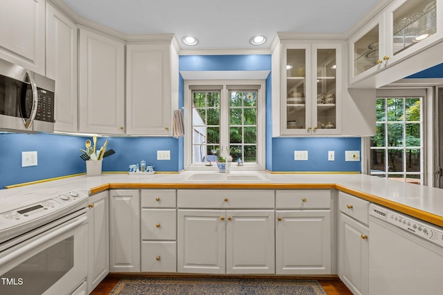 906 Grove St, Chapel Hill, NC 27517 - kitchen featuring white appliances, white cabinetry, light countertops, dark wood-style flooring, and recessed lighting