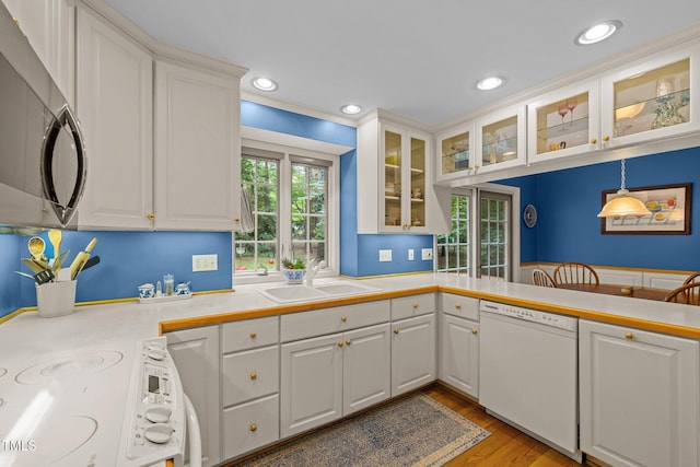 906 Grove St, Chapel Hill, NC 27517 - kitchen with dishwasher, stainless steel microwave, white cabinets, recessed lighting, and light countertops
