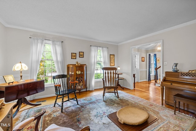 906 Grove St, Chapel Hill, NC 27517 - living area featuring a textured ceiling, wood finished floors, and crown molding