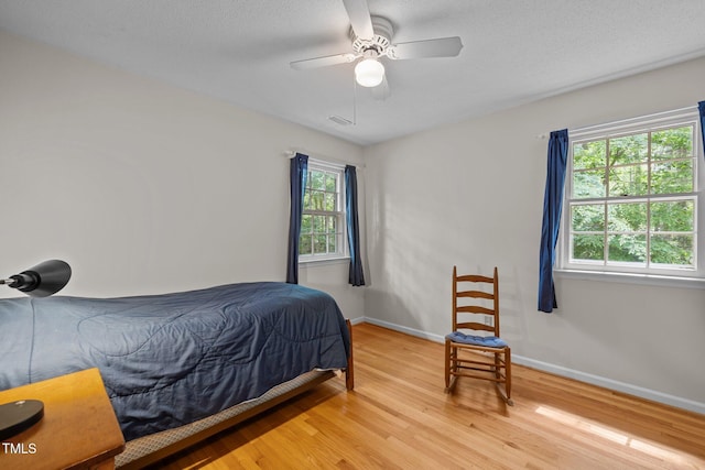 906 Grove St, Chapel Hill, NC 27517 - bedroom featuring light wood-style floors, ceiling fan, and a textured ceiling