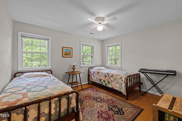 906 Grove St, Chapel Hill, NC 27517 - bedroom featuring wood finished floors, ceiling fan, and a textured ceiling