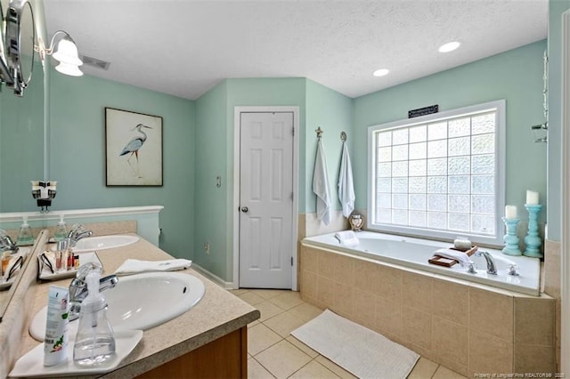 3313 Geyser Peak Rd, Fayetteville, NC 28306 - bathroom with double vanity, a garden tub, tile patterned floors, and a textured ceiling