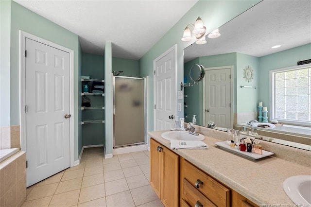 3313 Geyser Peak Rd, Fayetteville, NC 28306 - bathroom with a closet, a stall shower, double vanity, a garden tub, and tile patterned flooring