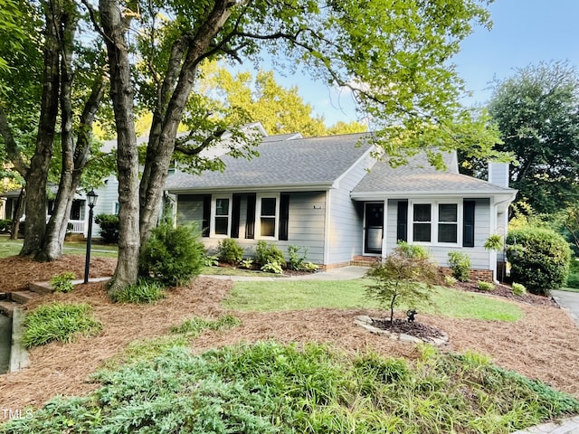 1507 Woodcroft Dr, Raleigh, NC 27609 - ranch-style home with a shingled roof, a chimney, and a front lawn