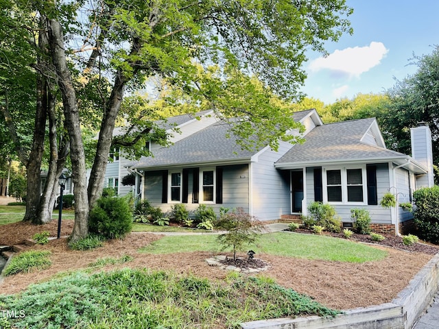 1507 Woodcroft Dr, Raleigh, NC 27609 - view of front of home with a shingled roof, a chimney, and a front lawn