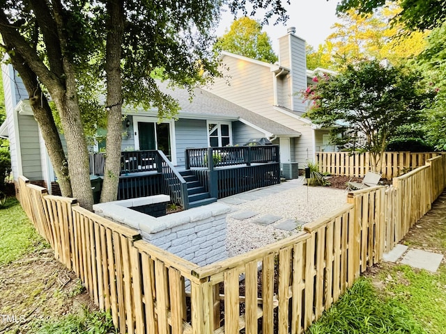 1507 Woodcroft Dr, Raleigh, NC 27609 - back of house with a chimney and a wooden deck