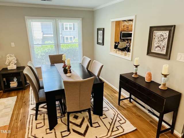 1507 Woodcroft Dr, Raleigh, NC 27609 - dining area featuring light wood-type flooring and ornamental molding