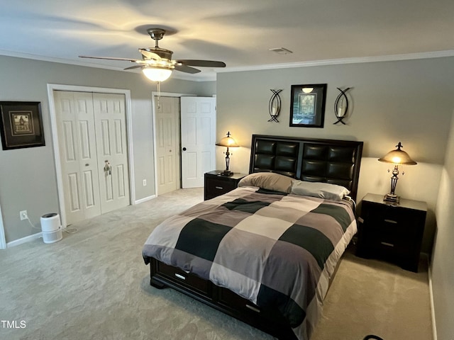 1507 Woodcroft Dr, Raleigh, NC 27609 - carpeted bedroom with multiple closets, crown molding, and a ceiling fan