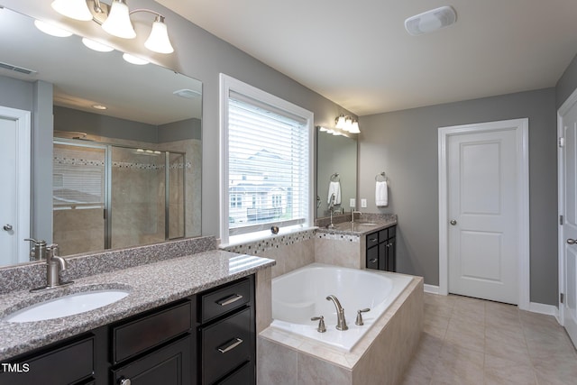 3913 Chapel Oak Dr, Apex, NC 27502 - bathroom featuring vanity, a shower stall, a bath, and tile patterned floors
