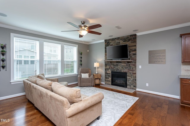 3913 Chapel Oak Dr, Apex, NC 27502 - living room with a ceiling fan, crown molding, dark wood-style floors, and a stone fireplace