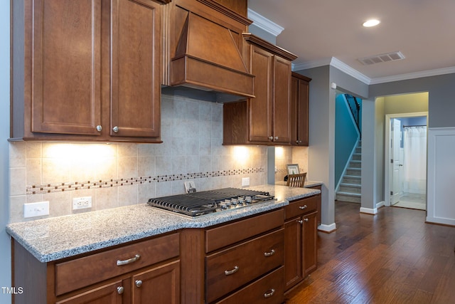 3913 Chapel Oak Dr, Apex, NC 27502 - kitchen featuring premium range hood, stainless steel gas stovetop, crown molding, dark wood-style floors, and light stone countertops